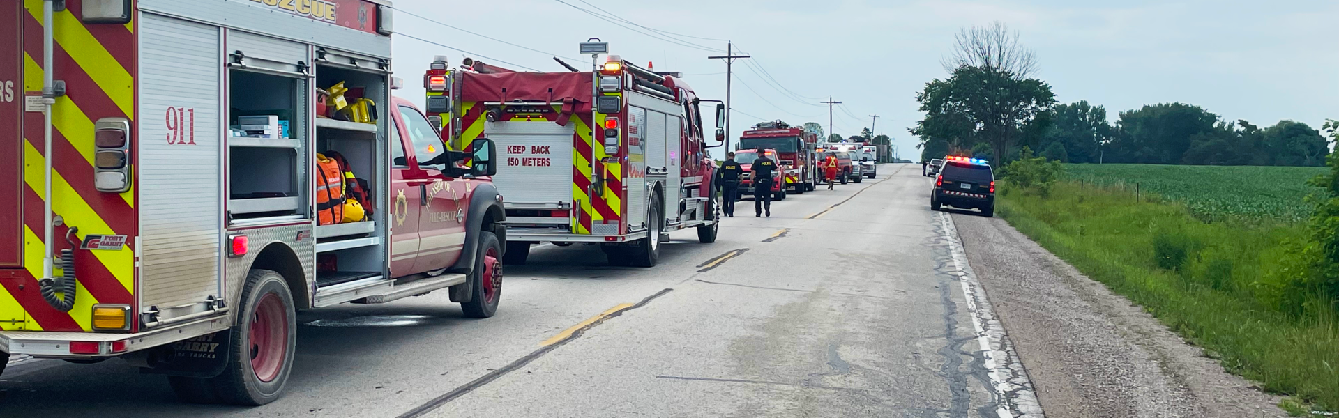 several emergency vehicles responding to a crash on a rural road