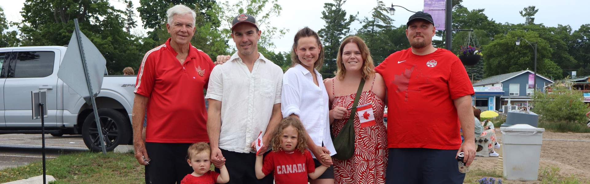 Family wearing red and white on the beach