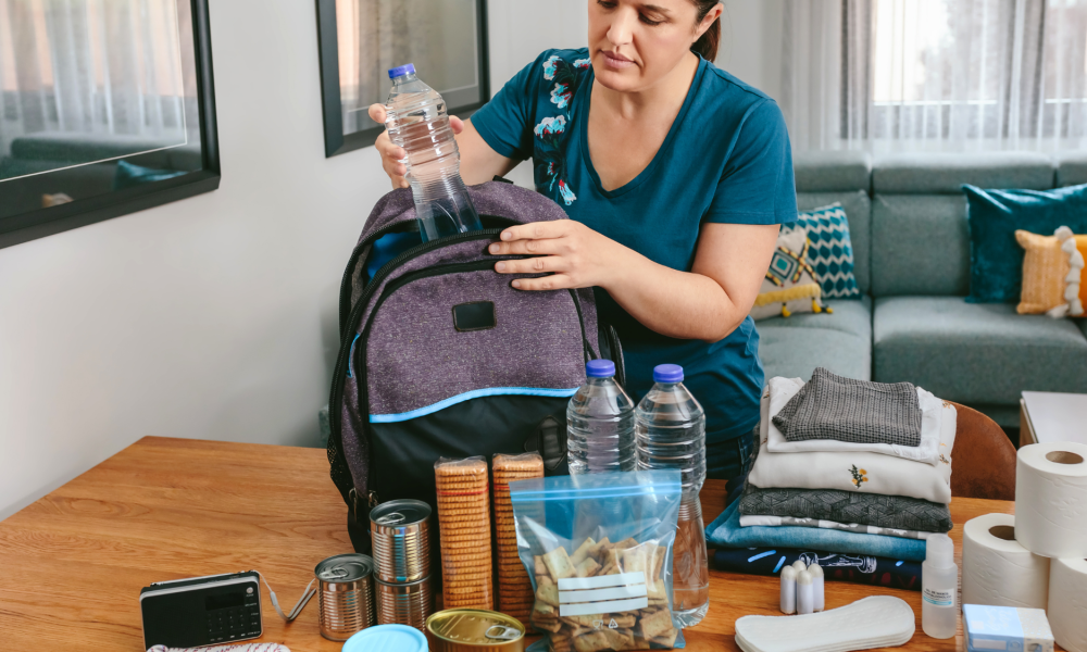 woman packing a backpack emergency kit