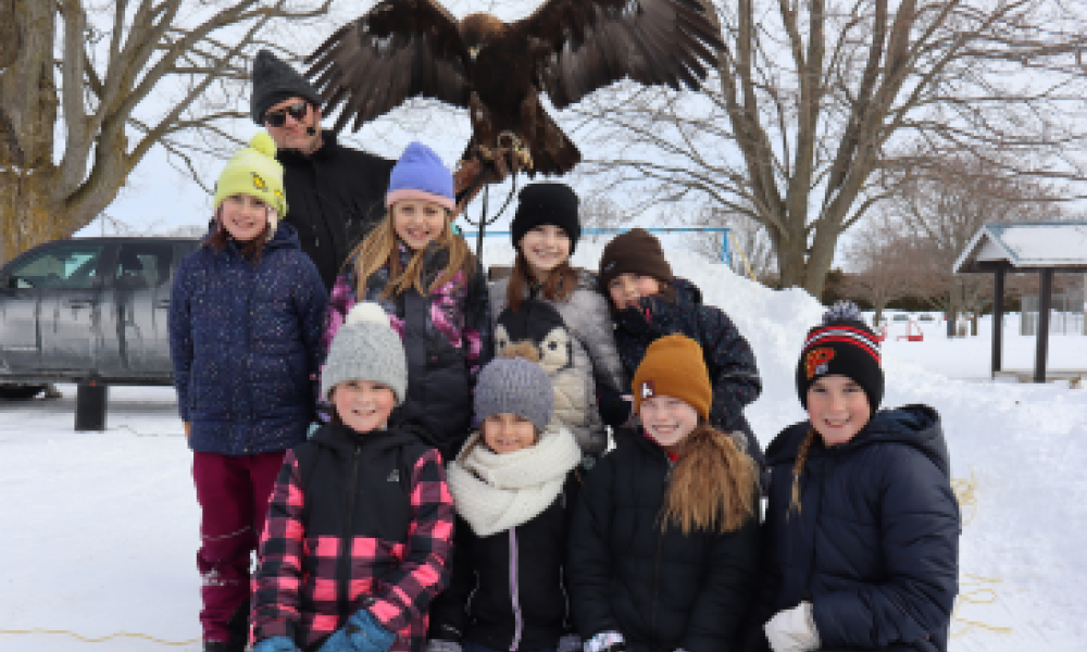 A group photo with a bird of prey.
