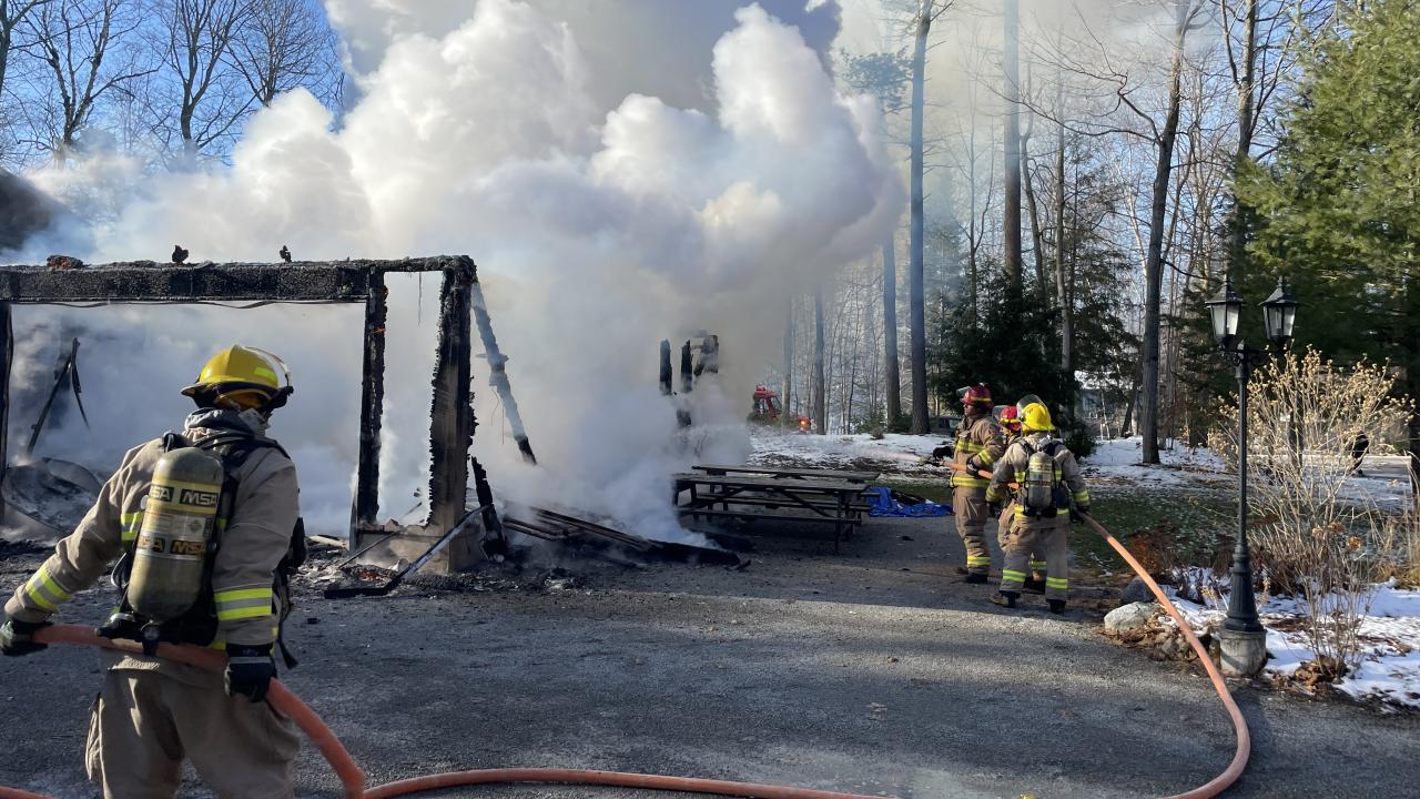 tiny firefighters responding to a fire call at a rural property