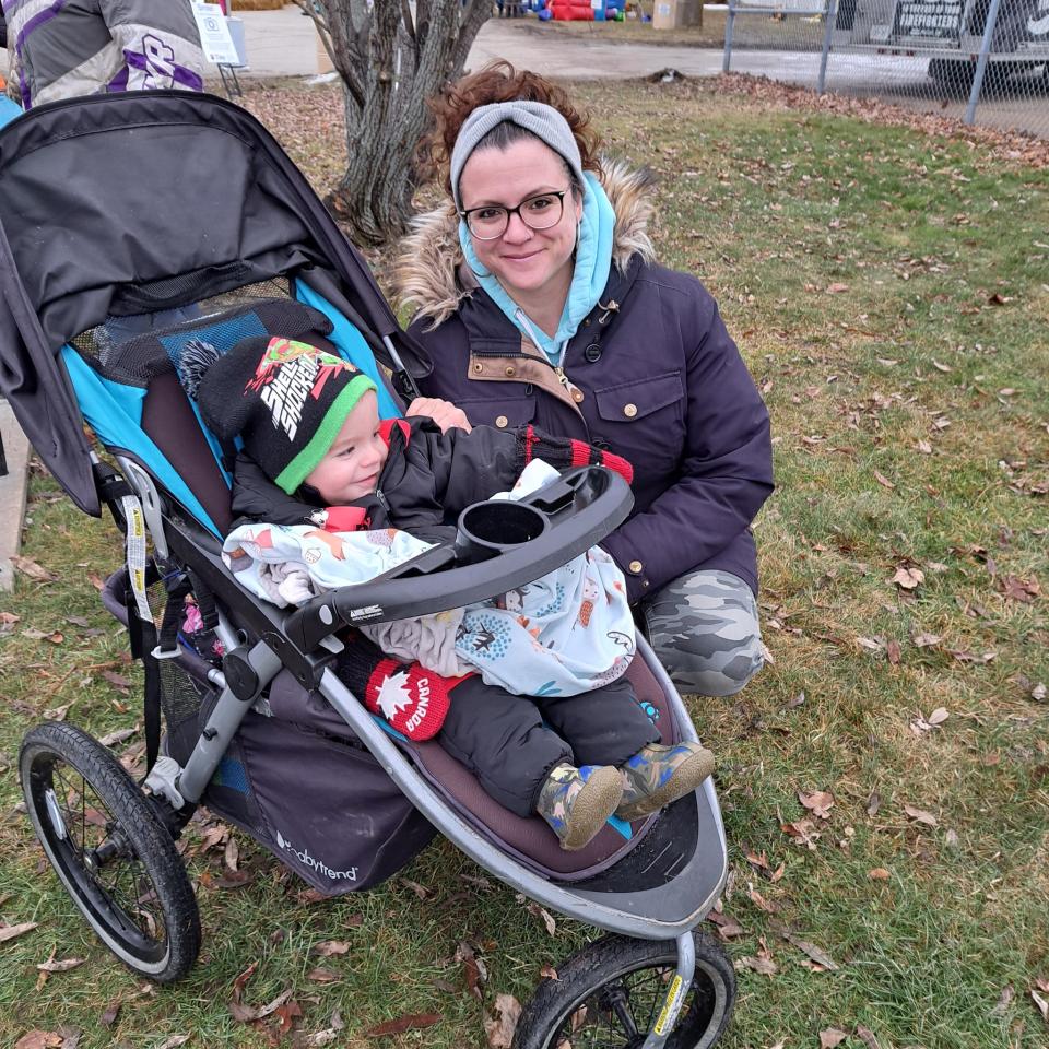 Woman smiling with child in a stroller