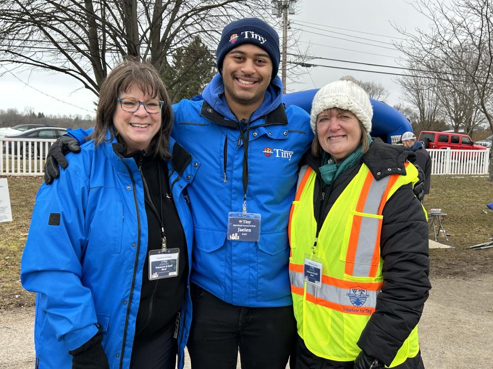 two members of staff and a volunteer all smiling at the event