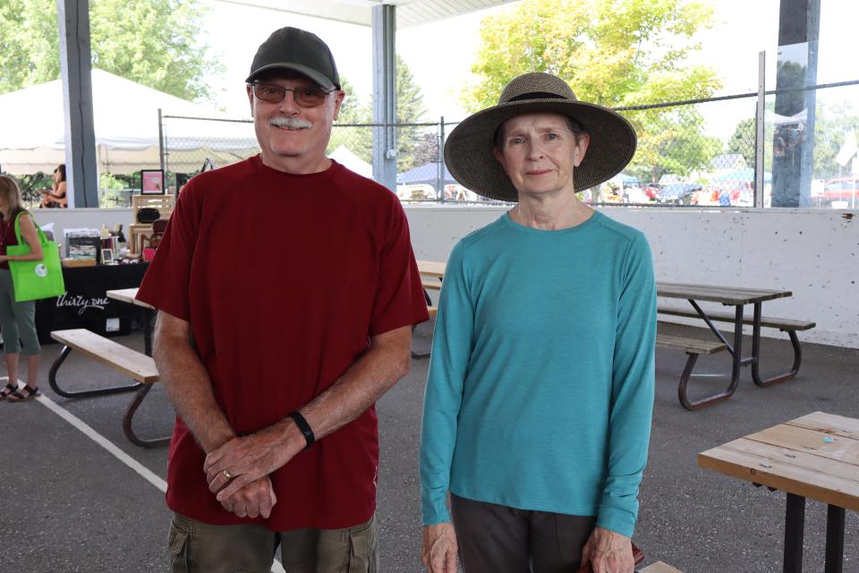 Couple posing for a photo while exploring the vendor fair