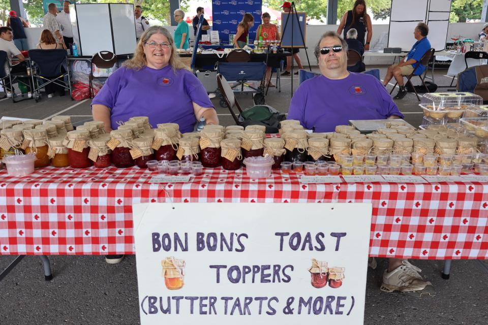 Couple sitting at the Bon Bons Toast Toppers booth with sweet treats and jams