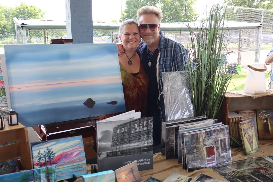 Couple standing behind their booth at the vendor fair