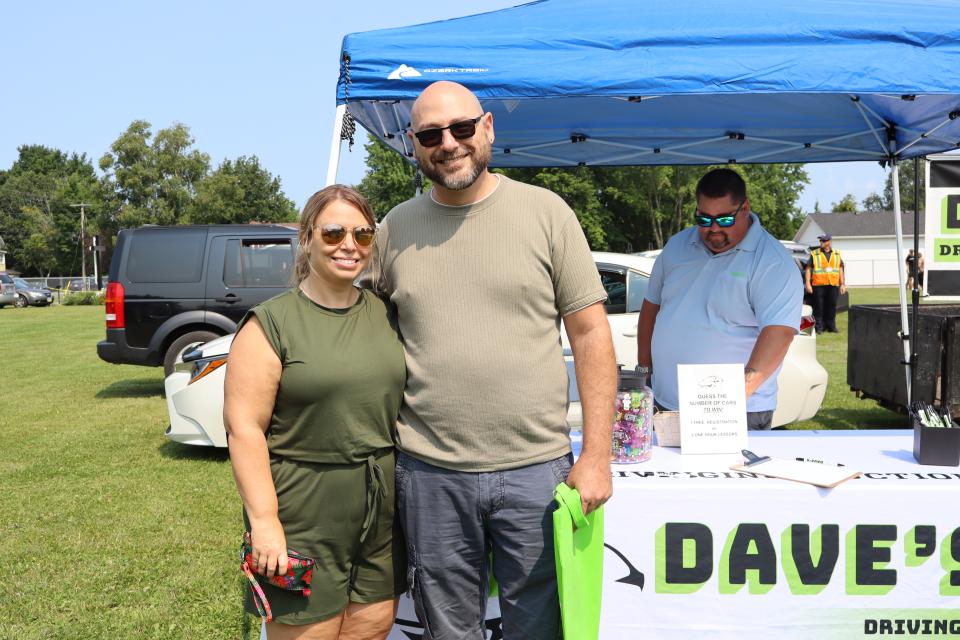 Couple visiting Dave's Driving School booth