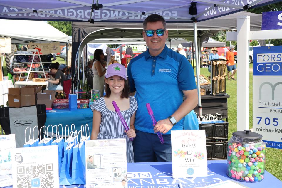 Dad and daughter at the For Sale on Georgian Bay booth