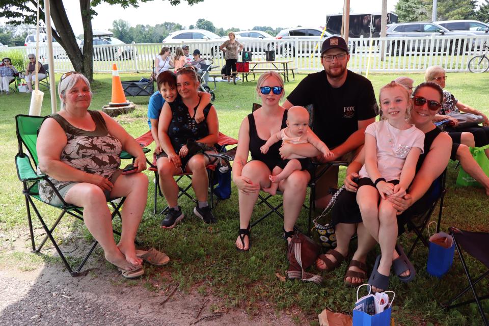 Family and friends sitting in their lawn chairs enjoying the live music