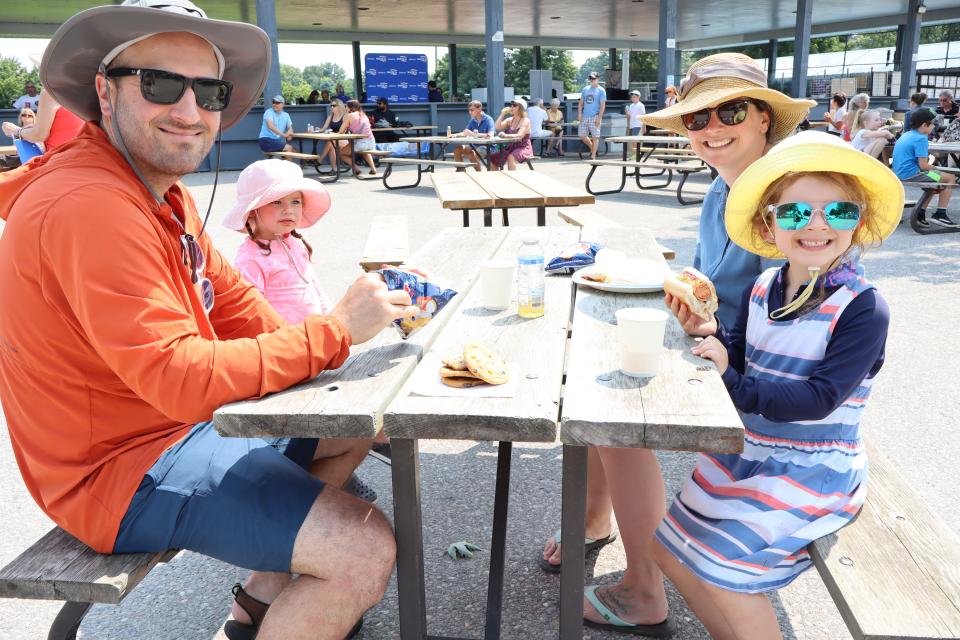 Family with young kids enjoying lunch at the BBQ