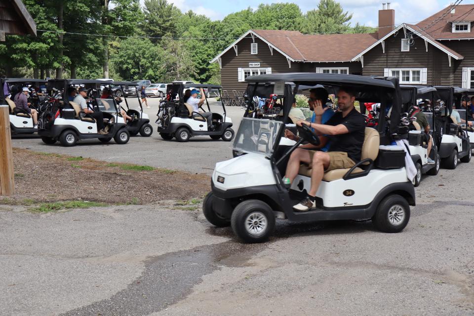 Golf cart drivers lined up heading out to their assigned holes