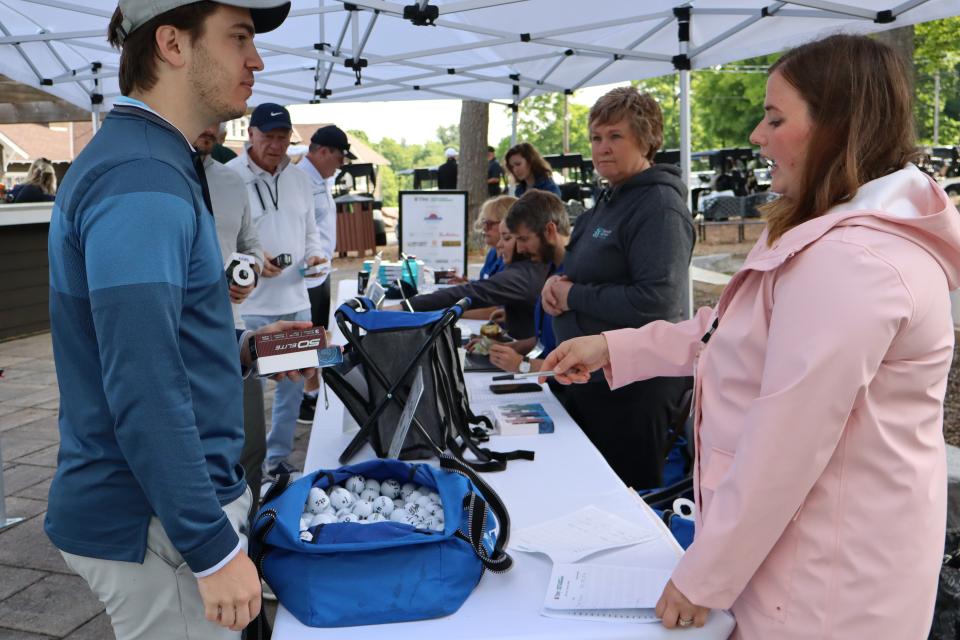 Golfers checking in at the registration table