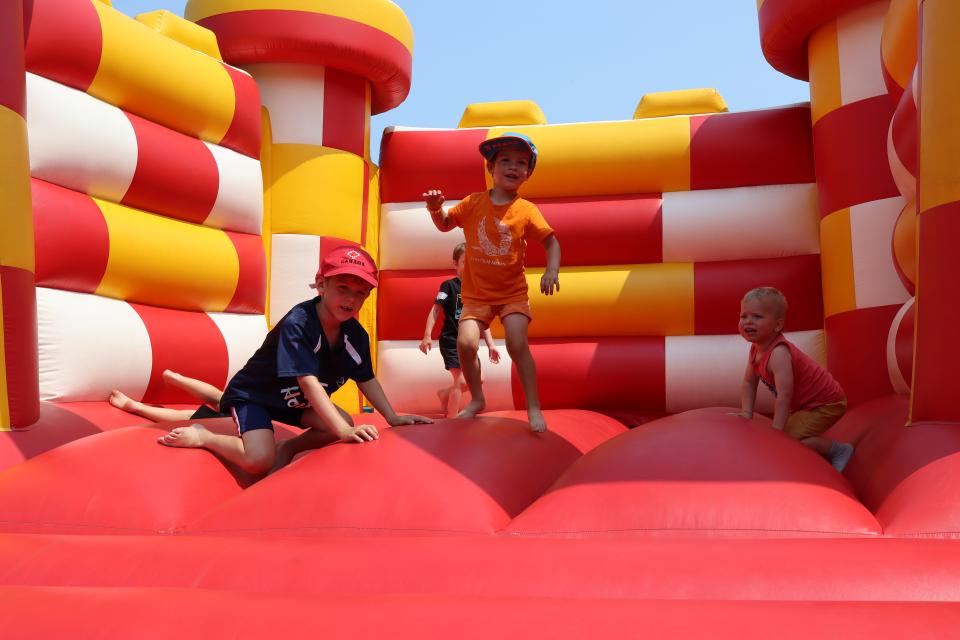 Group of young children playing on the bouncy castle