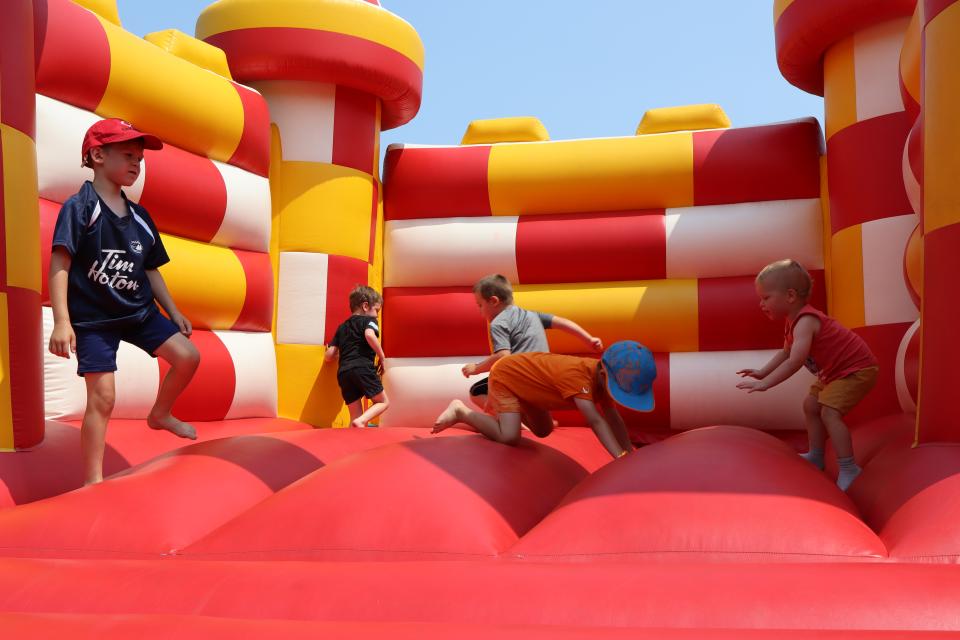 Group of young children playing on the bouncy castle