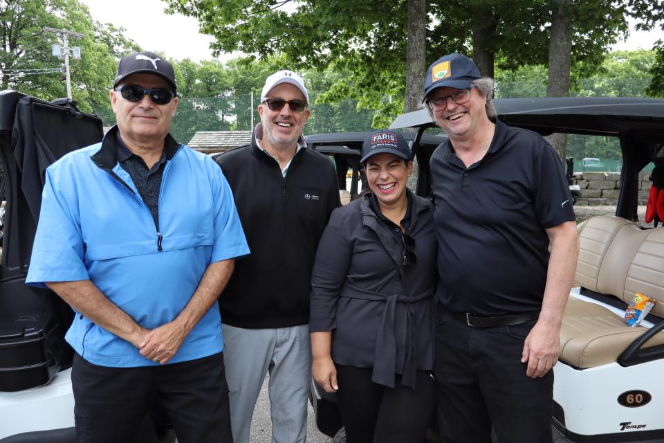 Mixed golf foursome in front of their carts