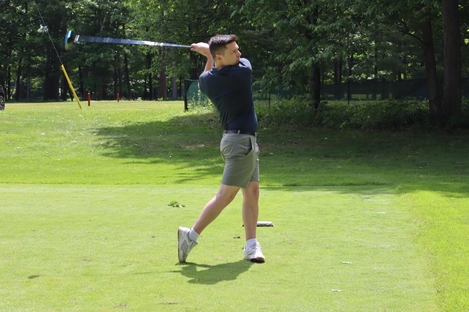 Male golfer after hitting the ball at the longest drive contest hole