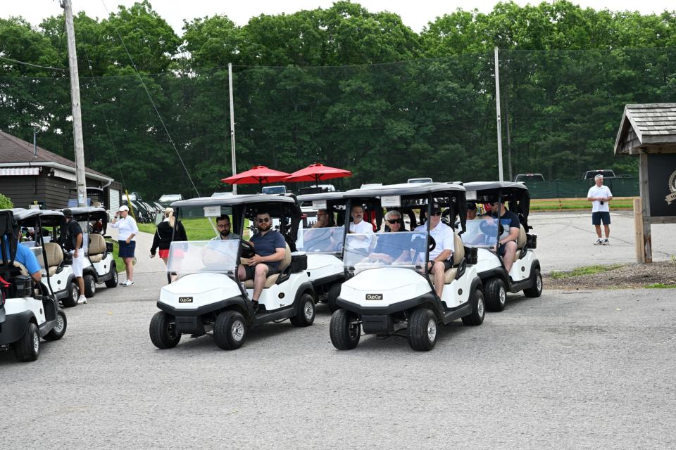 Line up of golf carts starting to head out to their assigned holes