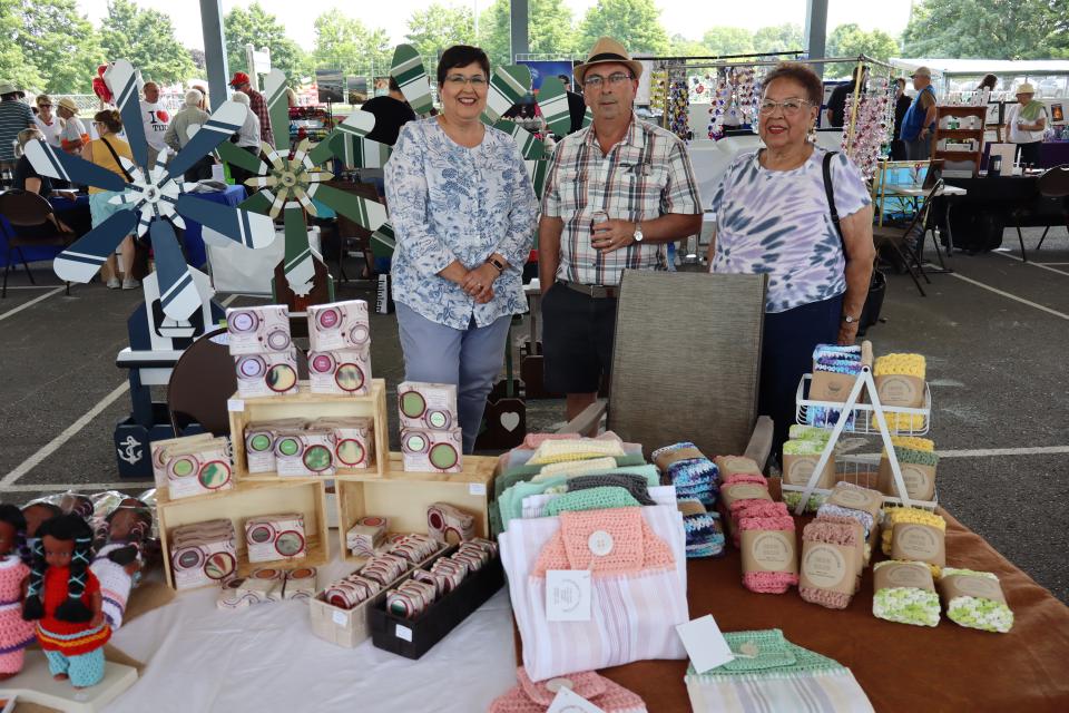 Man and two women at the Cascagnette Creations booth