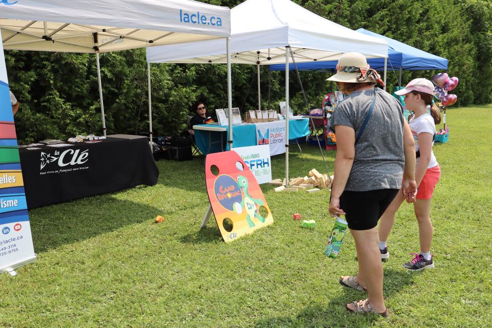 Mom and daughter playing a game at the La Cle tent