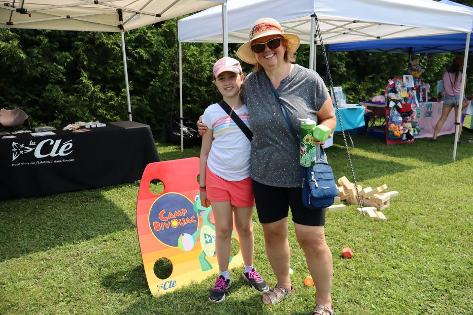 Mom and daughter posing for a photo in the family fun zone