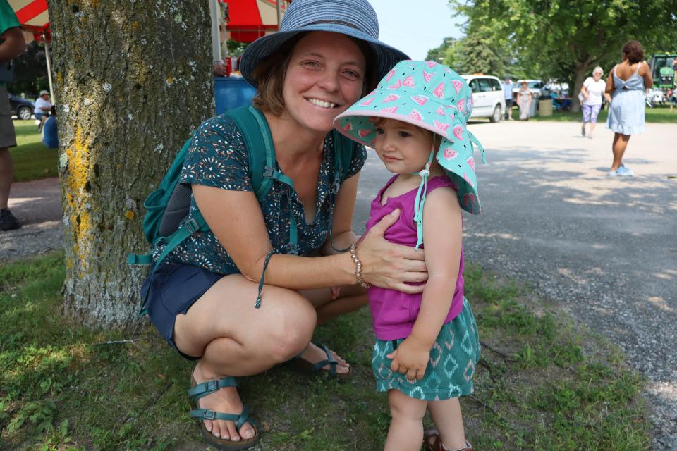 Mom bending down with young daughter