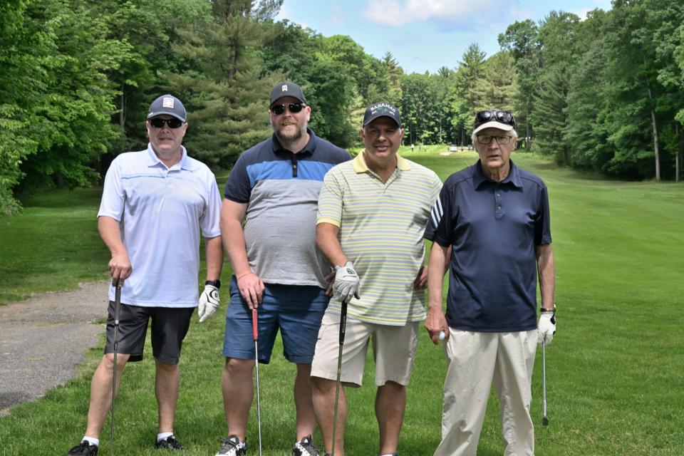 Men's golf foursome out on the greens