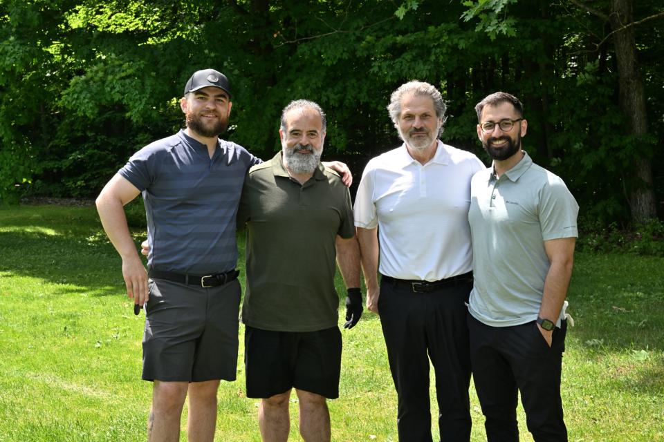 Men's golf foursome out on the greens