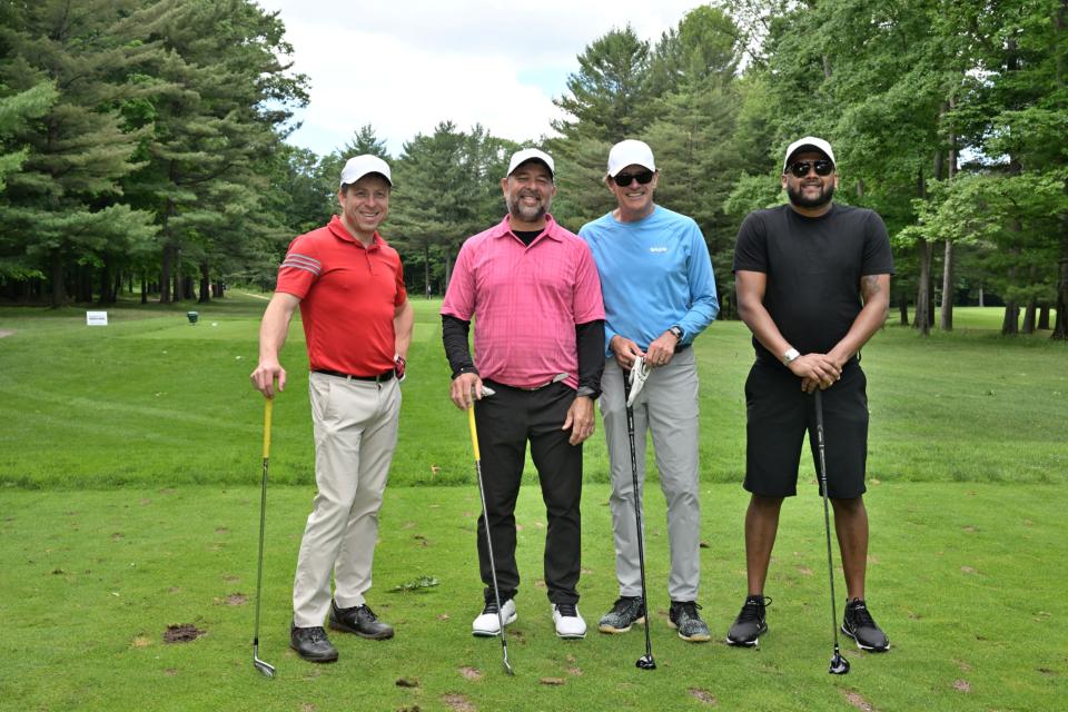 Men's golf foursome out on the greens