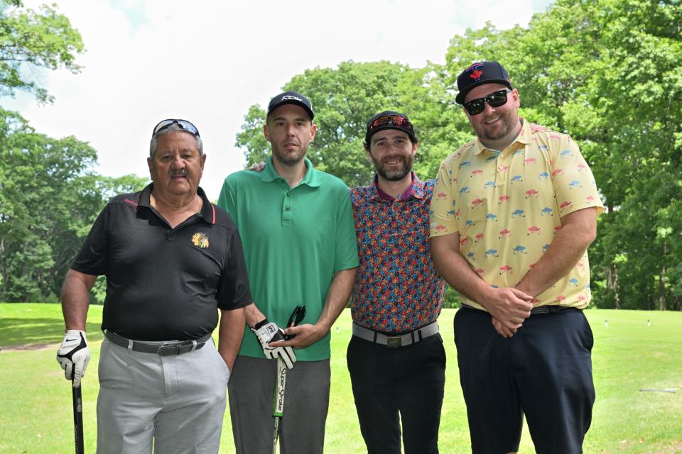 Men's golf foursome out on the greens