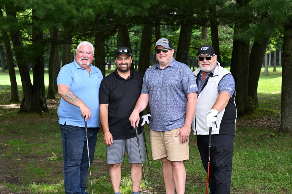 Men's golf foursome out on the greens