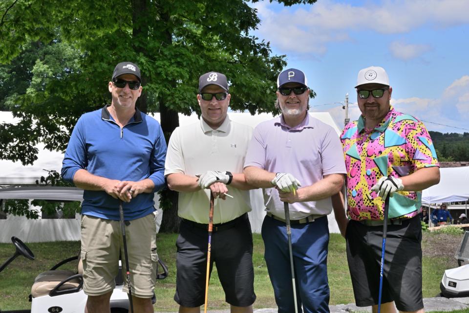 Men's golf foursome out on the greens