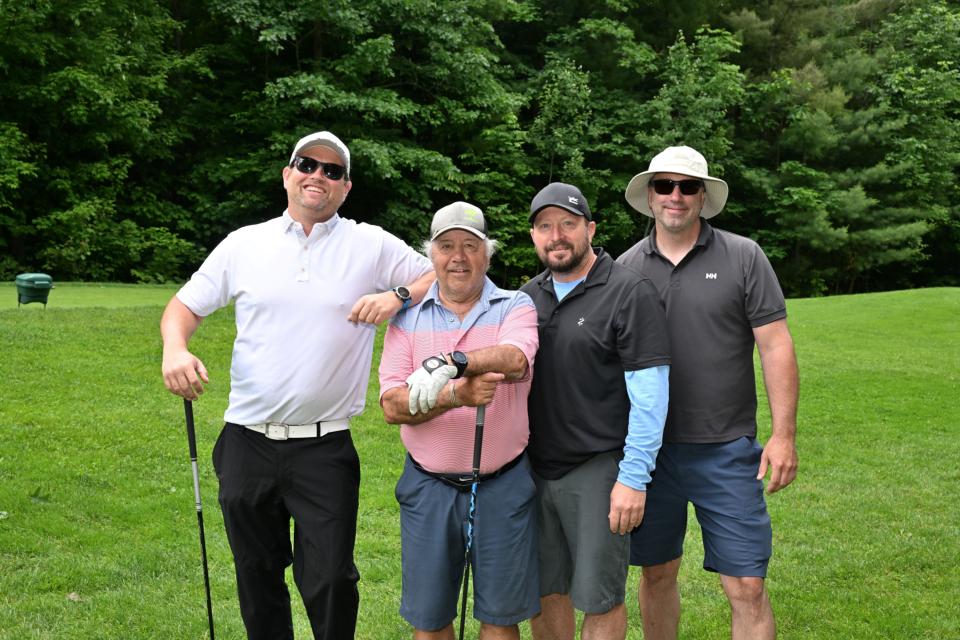 Men's golf foursome out on the greens