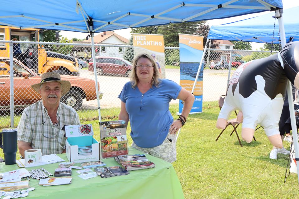 Representatives with farming information at their booth