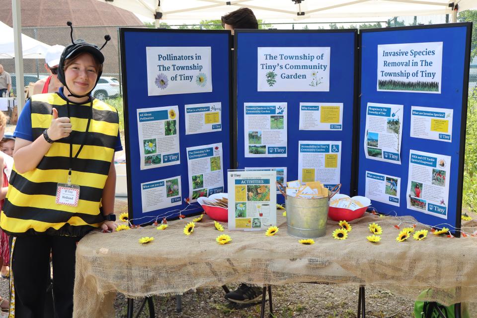 Tiny staff dressed as a bee in the pollinator showcase