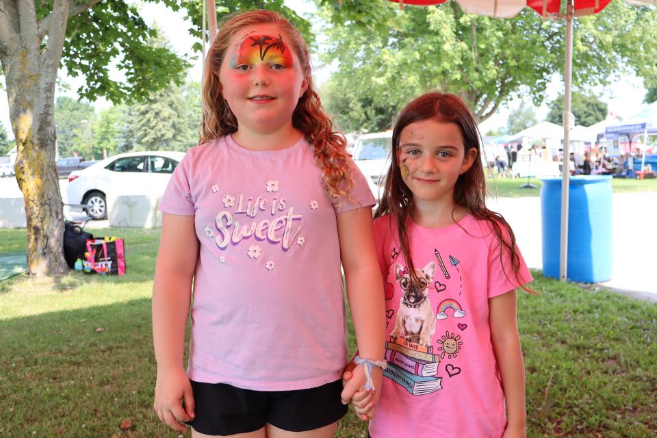 Two young girls with facepaint at the BBQ