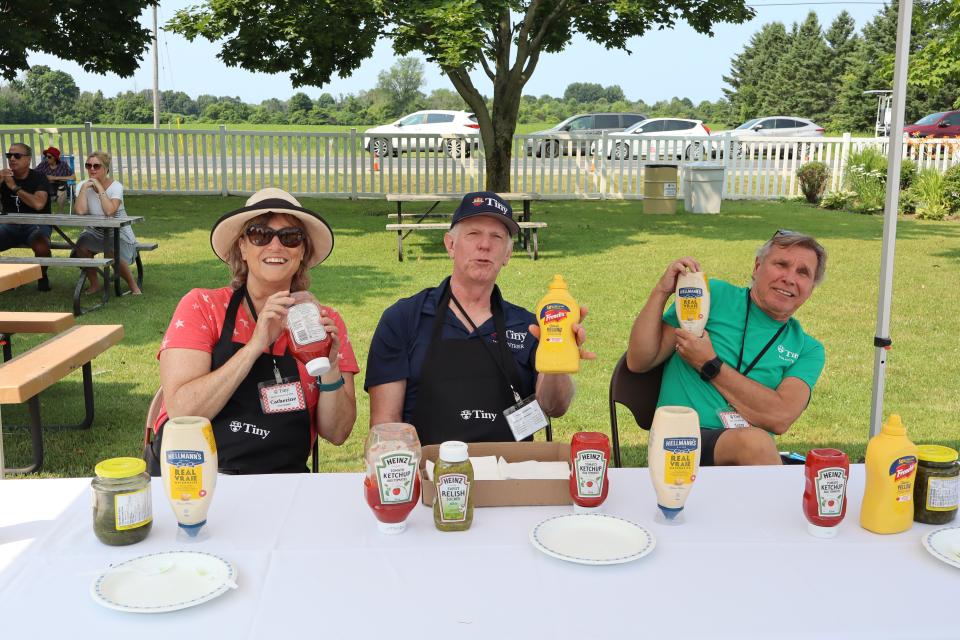 Volunteers at the condiments station