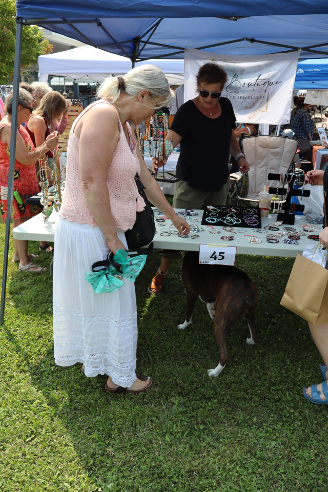 Woman and her dog browsing the vendor fair