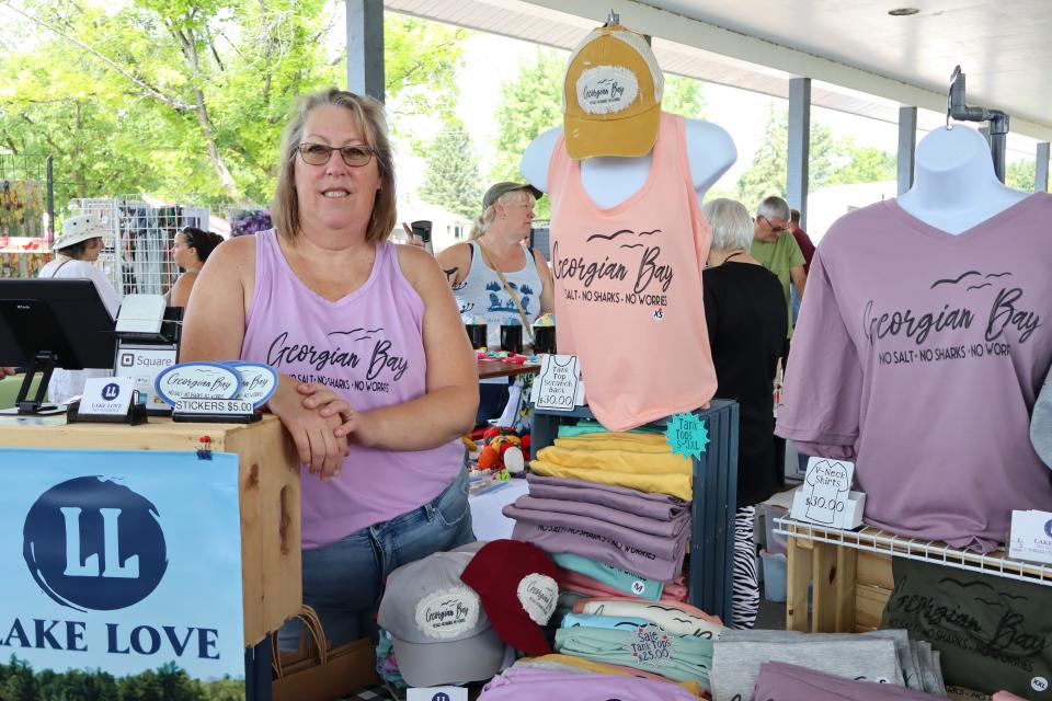 Woman posing for a photo wearing their Lake Love clothing brand