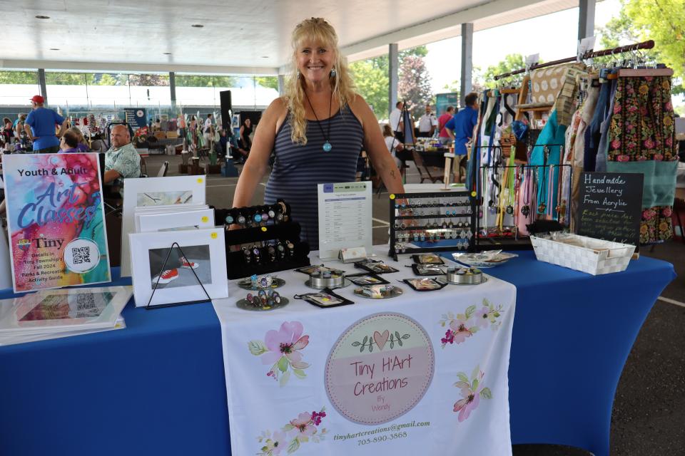 Woman standing behind their Tiny H'Art Creations booth