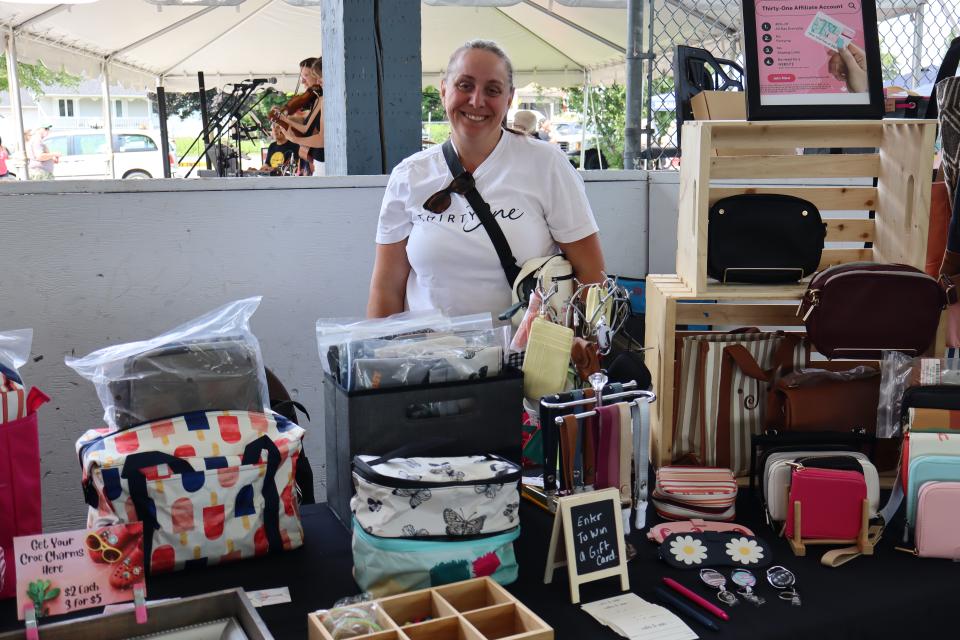 Woman standing in their Thirty One booth