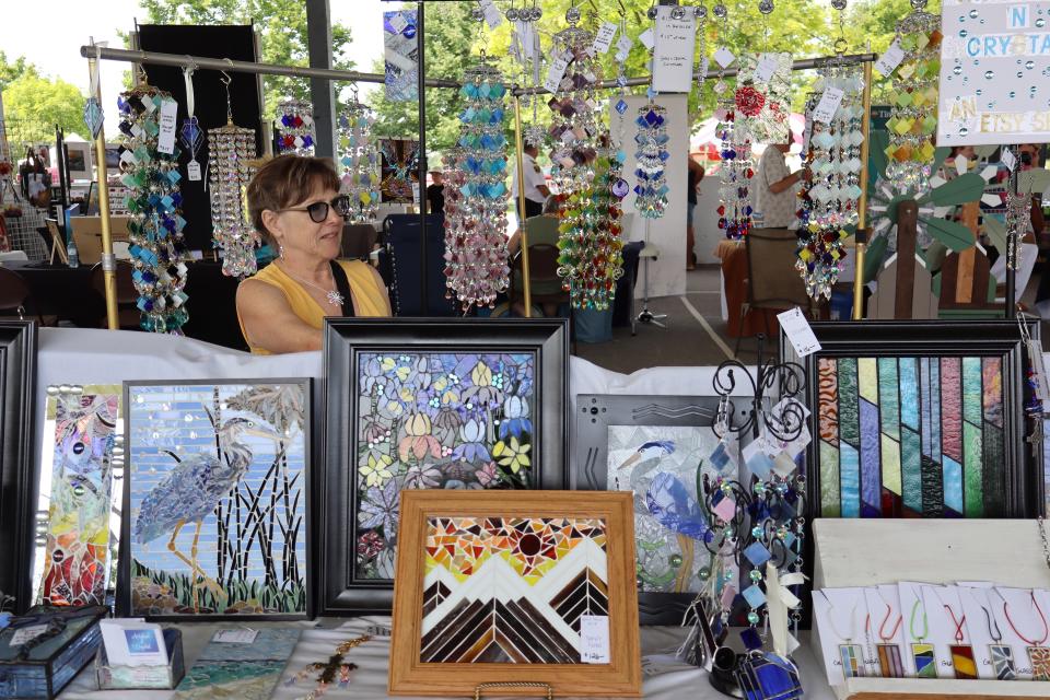 Woman standing in their art booth