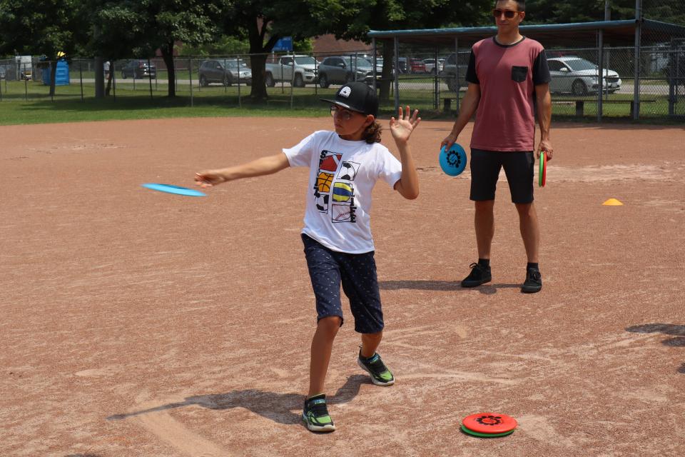 Young boy throwing a frisbee