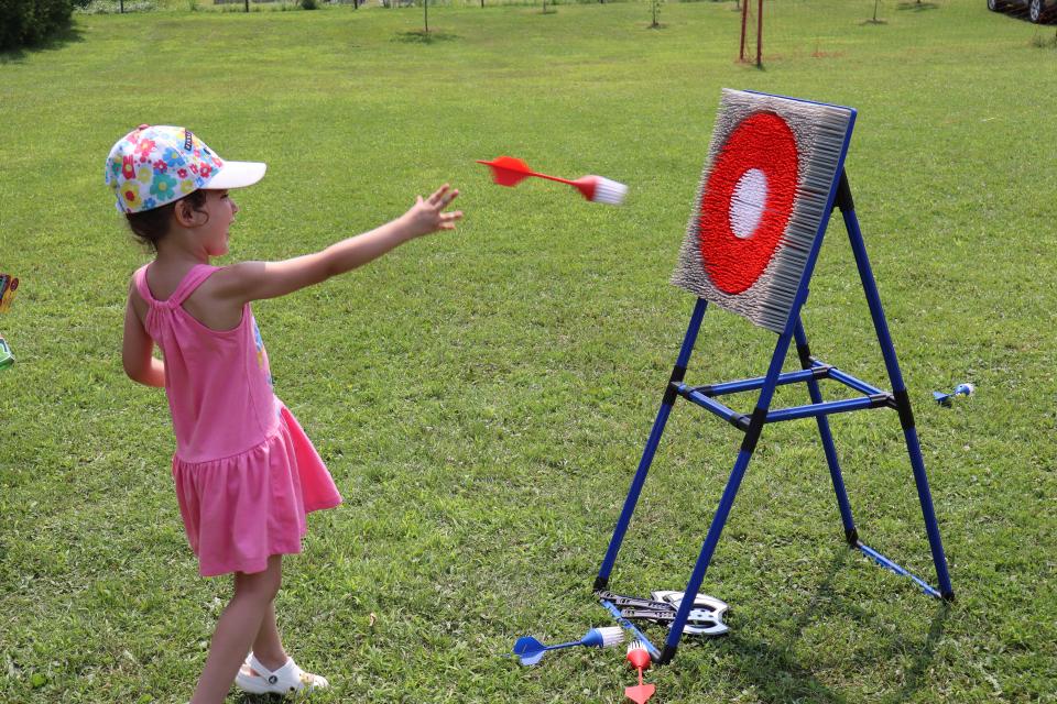 Young girl throwing a kids-friendly dart