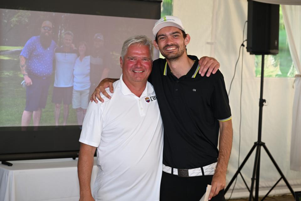 Mayor Evans congratulating the putting competition winner