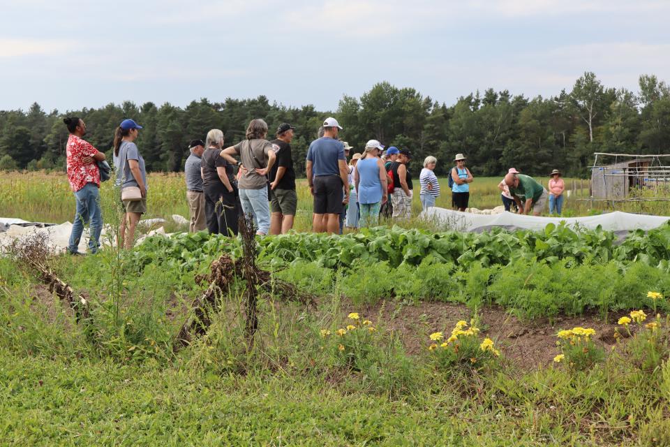 farm crawl participants learning about organic farming in the field