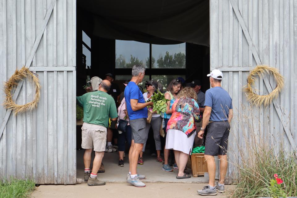 farm crawl participants visiting the farm stand inside the Thunder Beach Acres barn