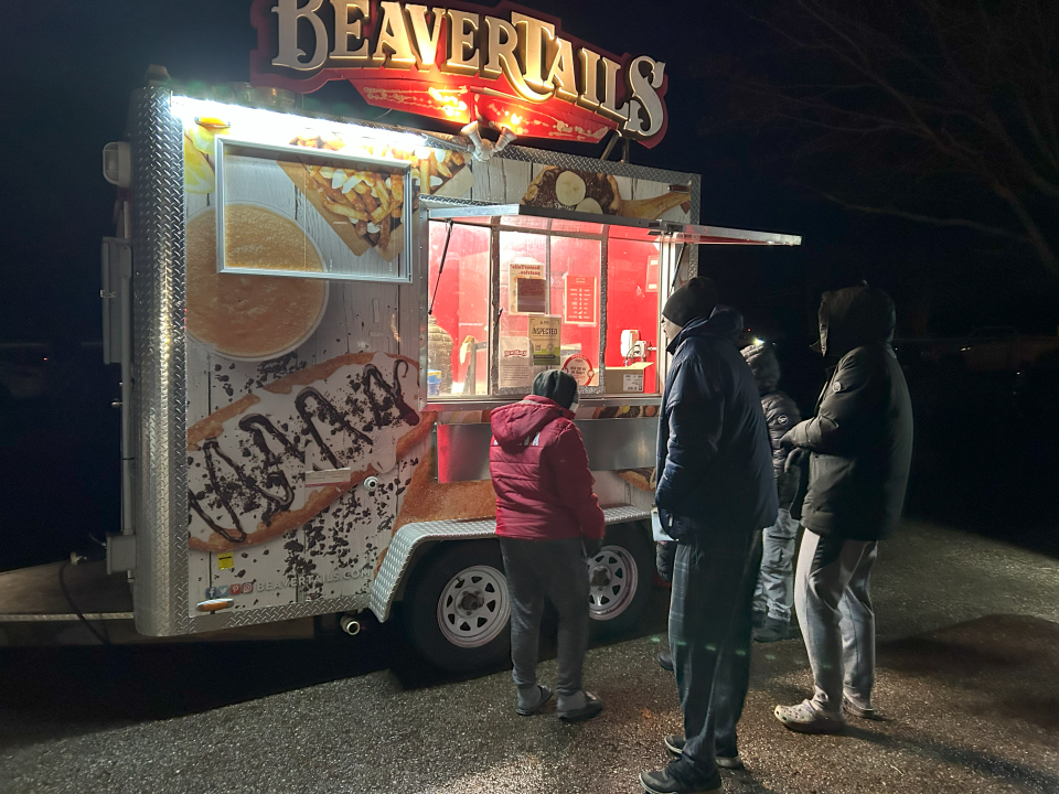 several people waiting in line to get a beavertail