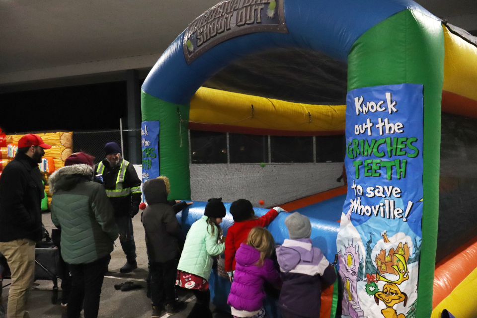 several children playing the inflatable grinch themed game in the Perkinsfield Pavilion with 