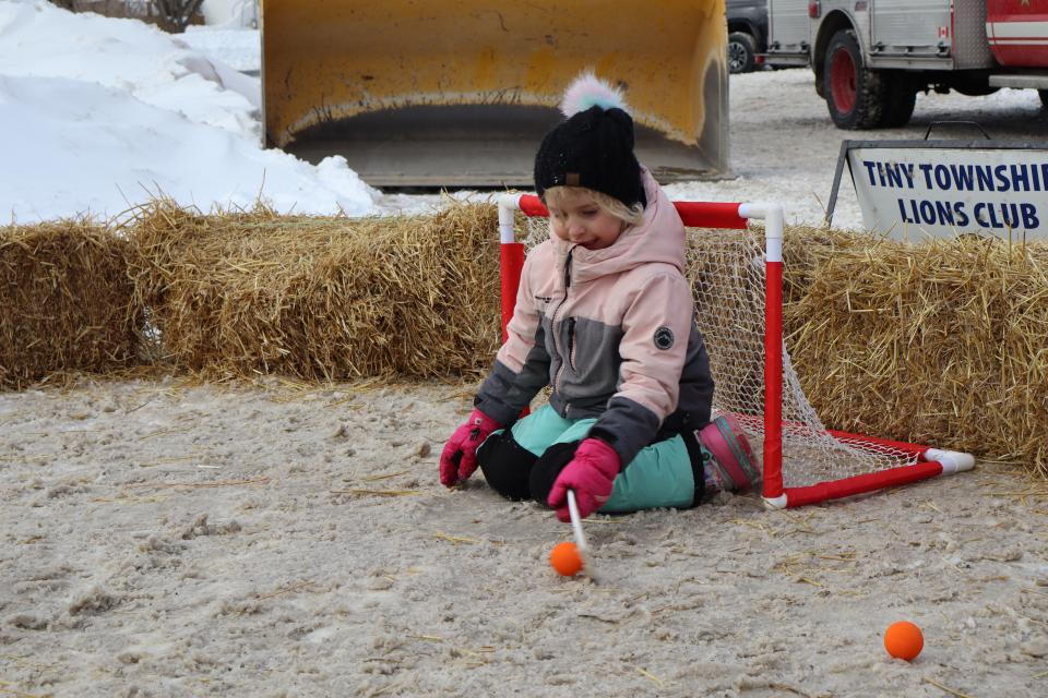 young girl playing mini stick hockey