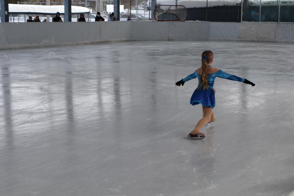 elmvale skater in a blue dress outfit performing a trick